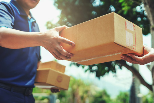 Courier on motorbike delivering parcel
